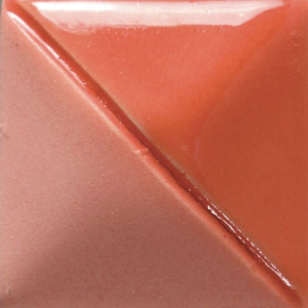 Close-up of a ceramic color swatch featuring a glossy coral glaze with a smooth transition to a matte pink hue.