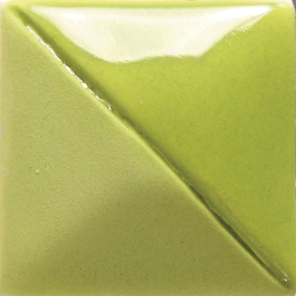 Glossy green ceramic glaze sample showing a diagonal split between two shades of green, ideal for pottery finishing.