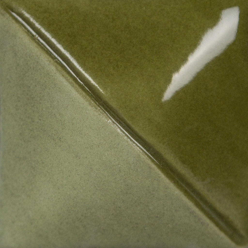 Diagonal split of matte and glossy green glazes on a ceramic tile, showcasing surface texture and color variation.