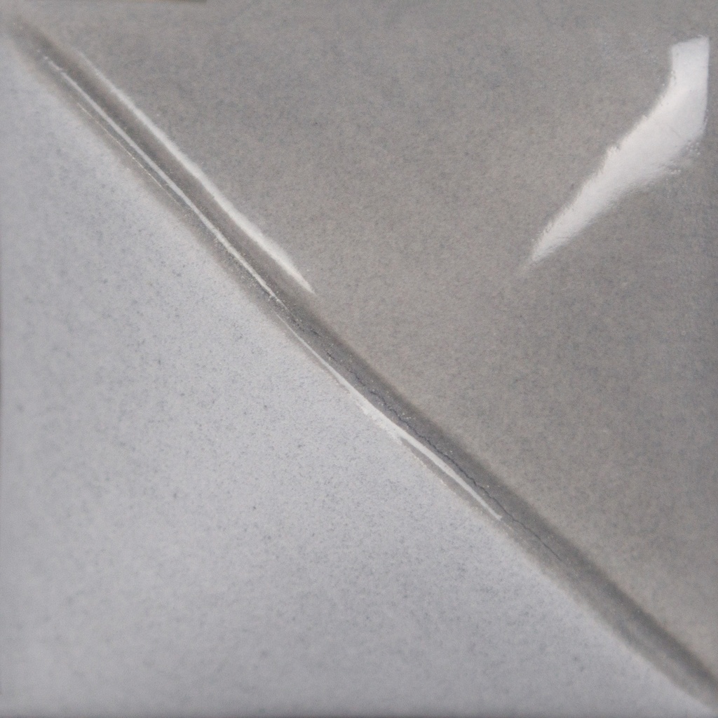 Gray and white ceramic glaze sample showing a smooth, glossy transition between the two colors, ideal for pottery finishes.
