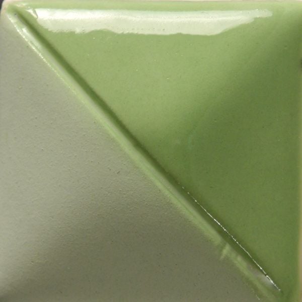Diagonal split ceramic tile showcasing a glossy green glaze on one side and a matte gray finish on the other.