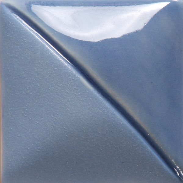 Glossy blue ceramic glaze sample in a triangular shape, showcasing a smooth texture and subtle shine.