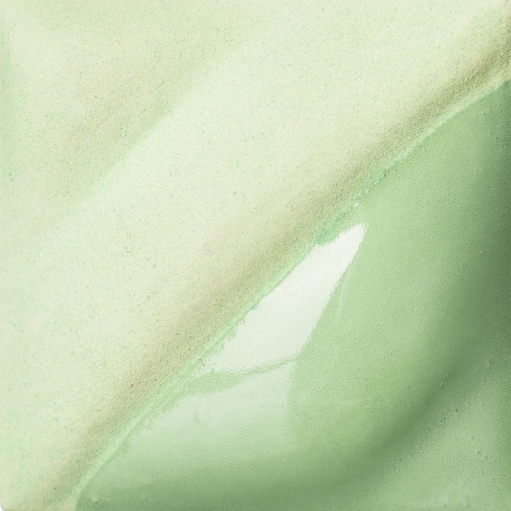 Glossy and matte green glaze sample on a ceramic tile, showcasing a blend of textures suitable for pottery firing.