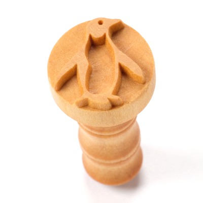 Wooden stamp featuring a carved penguin design, ideal for decorating ceramic pieces at Georgies Ceramic & Clay Company.