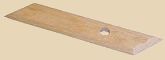 Wooden bat for pottery with a hole in the center, used for supporting clay projects during shaping and decorating.