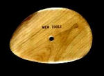 Wooden ceramic trimming tool with a smooth, ergonomic shape and a hole for easy handling, ideal for shaping clay.