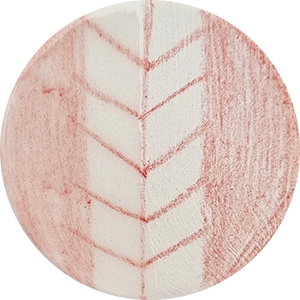 A round ceramic piece featuring a red ochre glaze decoration with a chevron pattern on a white clay background.