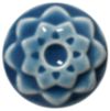 A blue ceramic flower-shaped button with a central hole and textured petals, showcasing glazes and detailing techniques.