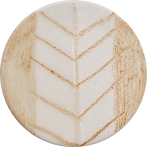 Unfinished clay round with a leaf pattern, showcasing carving technique for pottery decoration at Georgies Ceramic & Clay Company.