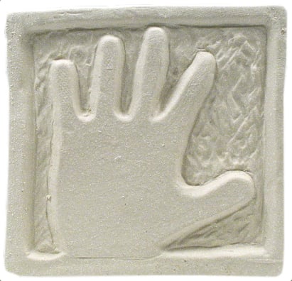 Hand-shaped relief impression in bisque clay, showcasing texture and detail, ideal for ceramic sculpting or casting projects.