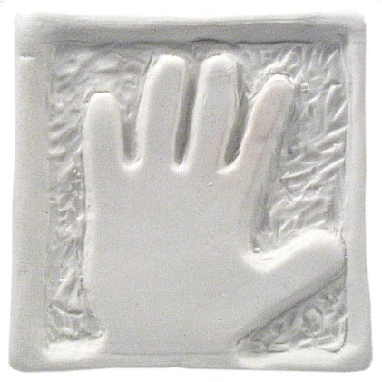 Imprinted clay tile featuring a hand design, showcasing texture and detail, ideal for ceramic art and decoration.