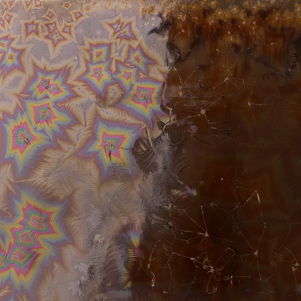 Colorful crystalline glaze patterns on a ceramic surface, showcasing iridescent designs suitable for pottery finishes.