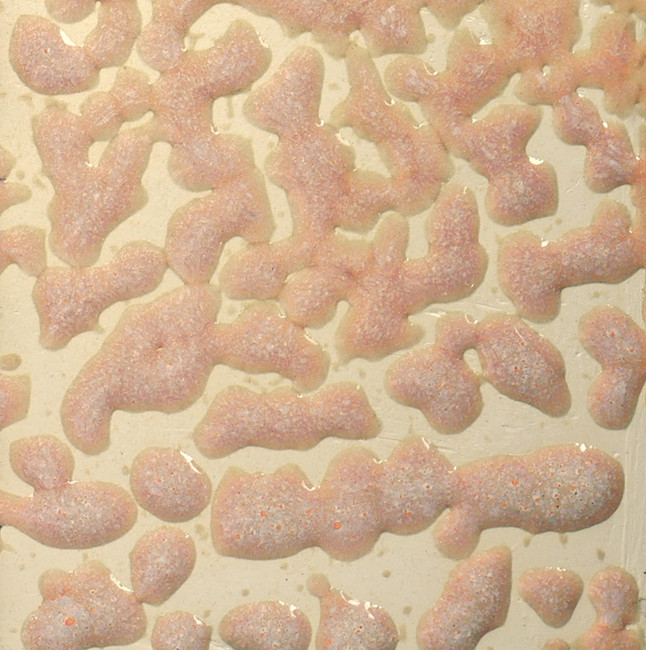 Close-up of a textured ceramic glaze showcasing soft pink, peach, and cream colors with a varied surface pattern.