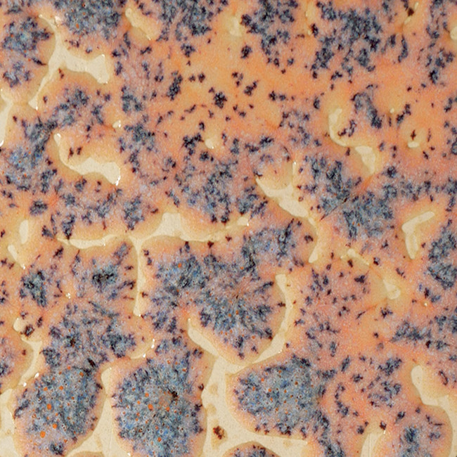 Close-up of textured ceramic glaze showing a blend of orange and blue patterns on a clay surface, ideal for pottery decoration.