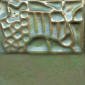 Textured ceramic tile displaying a variety of patterns in earthy tones, suitable for glazing and decorative projects.