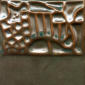 Textured clay slab with a decorative pattern, featuring glossy green and brown glazes, suitable for ceramics projects.