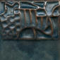 Textured ceramic tile featuring a glossy blue glaze with intricate patterns, ideal for decorating pottery or sculptures.