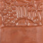 Textured clay relief featuring a detailed design, suitable for ceramic decoration or sculpture enhancement in pottery.
