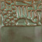 Textured ceramic tile with a green glaze and raised patterns, showcasing a detailed landscape design in clay.