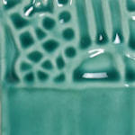 Teal ceramic glaze with textured patterns, showcasing a glossy finish ideal for pottery and sculptural applications.
