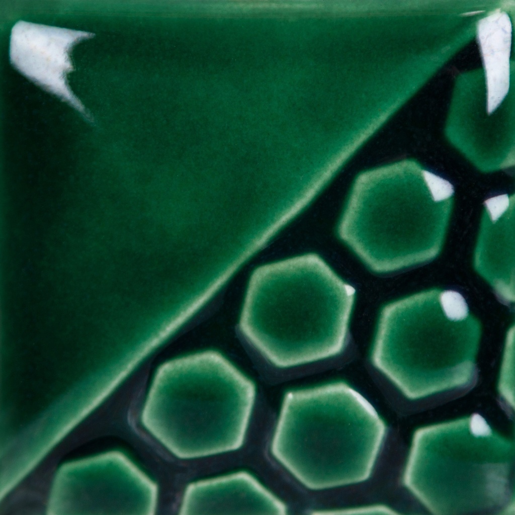 Green ceramic tile featuring a honeycomb texture and glossy glaze, showcasing a design suitable for decorative pottery.