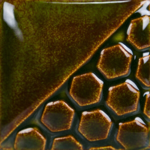 Close-up of a ceramic tile featuring a glossy olive green glaze and honeycomb texture, showcasing surface depth and color variation.
