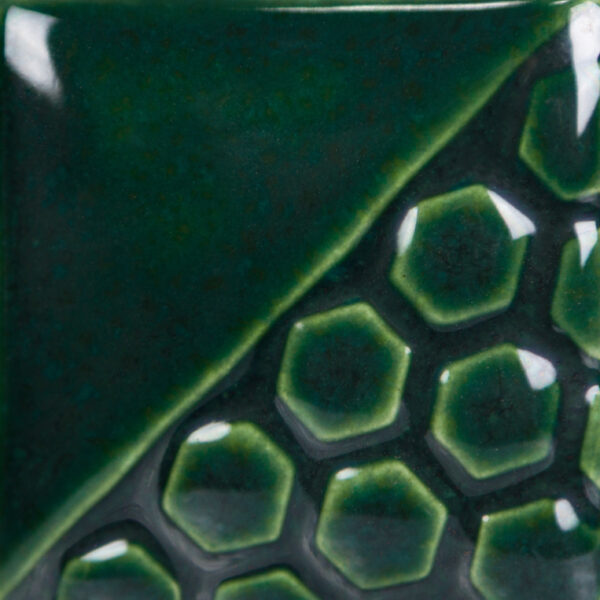 Dark green ceramic tile with glossy glaze, featuring a smooth triangular area and a hexagonal textured pattern.