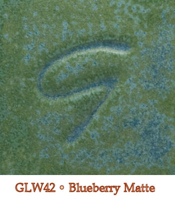 GLW42 Blueberry Matte glaze showing a textured, greenish-blue surface with subtle variations in color and sheen.