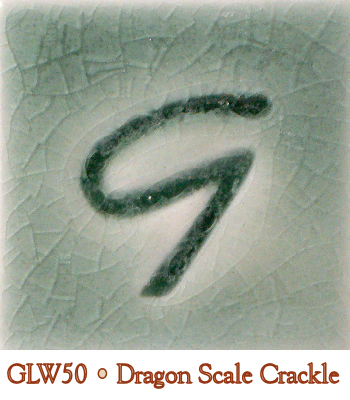 GLW50 Dragon Scale Crackle glaze sample featuring a textured, cracked surface with a greenish hue and a stylized 'G' marking.