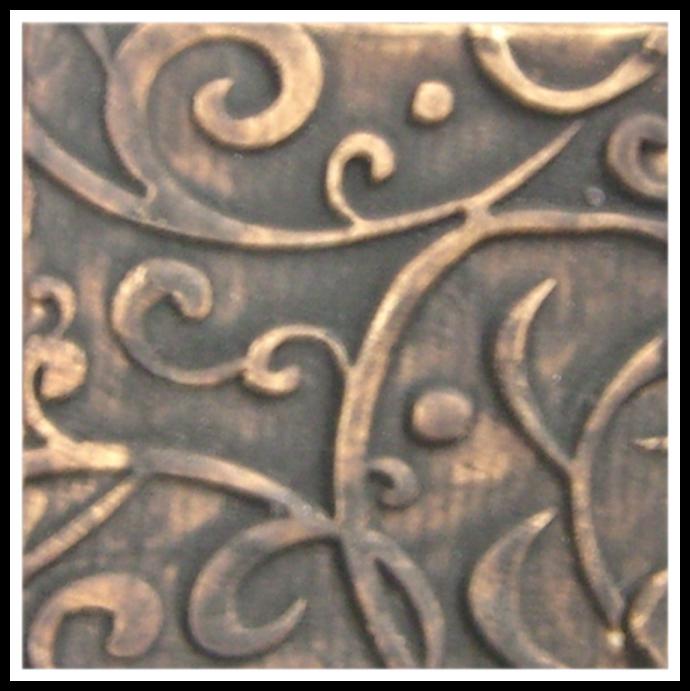 Detailed close-up of a textured ceramic surface featuring intricate swirling patterns in rich, dark brown and gold tones.