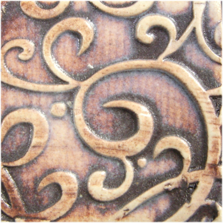Decorative ceramic tile with intricate swirled designs in earthy tones and a glossy glaze finish, ideal for pottery projects.
