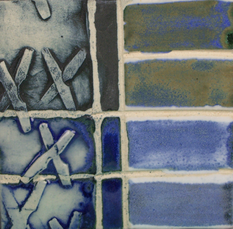 Textured ceramic tiles in shades of blue, gray, and green, showcasing glaze variations and decorative techniques.