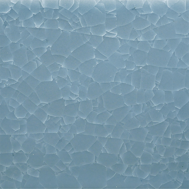 Fired ceramic glaze swatch in light blue, showing a crackle finish with textured surface variations.