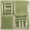 Glossy green ceramic tile featuring textured patterns and shapes, ideal for pottery decoration and glazing techniques.