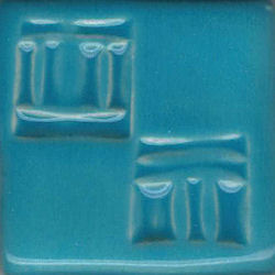 Textured turquoise ceramic glaze sample with matte finish, featuring two embossed designs, suitable for pottery decoration.