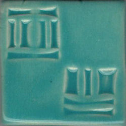 Textured turquoise ceramic tile showcasing raised geometric designs, ideal for pottery decoration and glazing techniques.