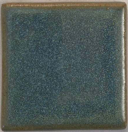 Textured ceramic tile with a blue-green glaze, showcasing a speckled surface and smooth edges, suitable for pottery projects.