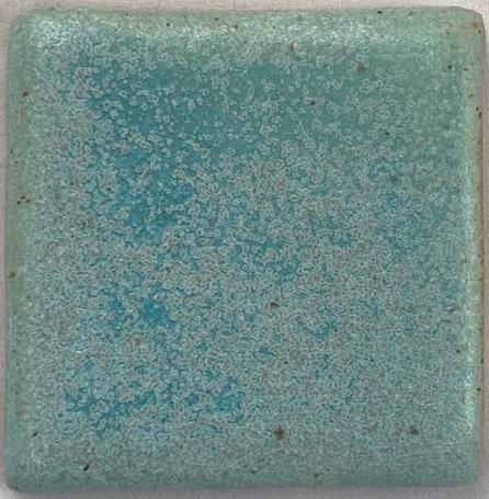 Textured aqua ceramic glaze sample on a square tile, showcasing a speckled surface with varying shades of blue.
