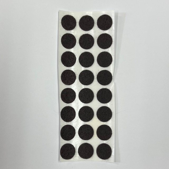 Sheet of adhesive felt pads in circular shape, used for protecting pottery surfaces and stabilizing ceramic pieces.