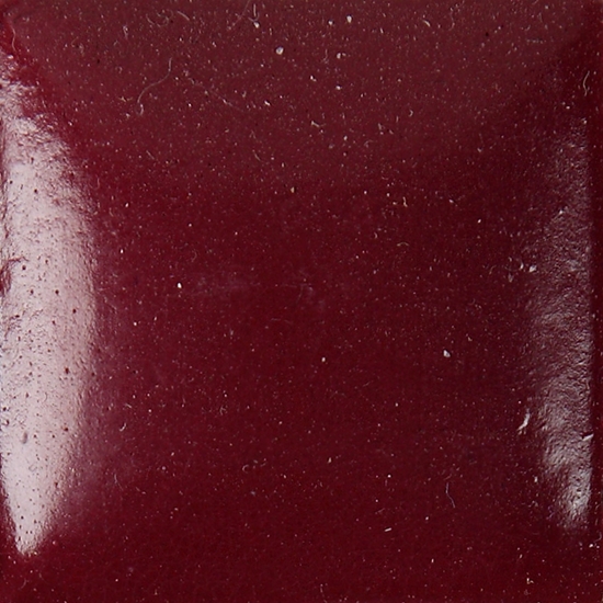 Glossy dark red ceramic glaze sample, showcasing a smooth surface ideal for pottery and decorative pieces.