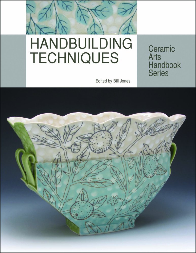 Ceramic bowl with hand-painted floral designs in green and blue, featuring tab handles, showcasing handbuilding techniques.