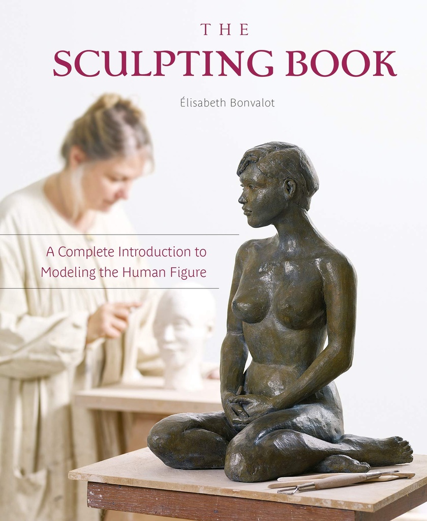 A seated clay sculpture of a human figure sits on a table, with sculpting tools in the foreground and an artist working in the background.