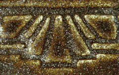 Close-up of a textured bronze ceramic glaze with a shimmering finish, showcasing an intricate design suitable for pottery.