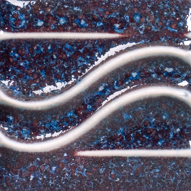 Rich, textured ceramic glaze with blue and maroon tones, featuring flowing white lines for decorative effect.