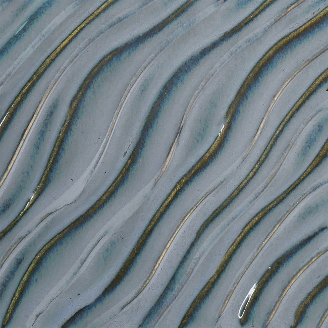 Textured ceramic surface with flowing blue glaze and gold line accents, showcasing fluid patterns and depth.