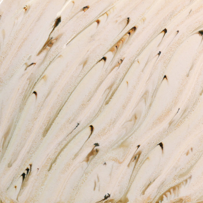 Swirled beige and brown ceramic glaze showing texture, ideal for decorative pottery finishes and studio projects.