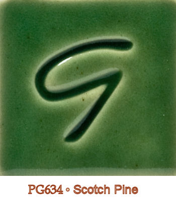 Green ceramic glaze sample labeled PG634 Scotch Pine featuring a stylized letter G embossed in the center.