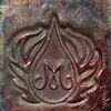 Glazed ceramic stamp featuring a decorative monogram surrounded by leaf motifs, ideal for pottery embossing.
