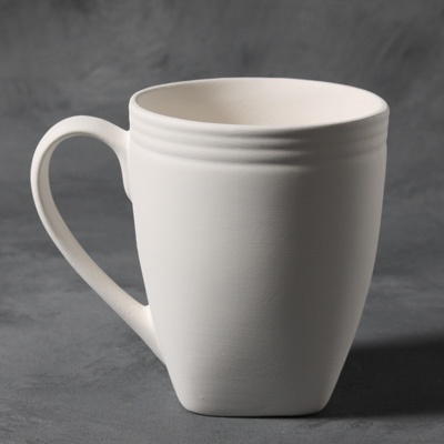 White ceramic mug with a smooth, unglazed surface and textured ribbing, ideal for hand-decorating and glazing.