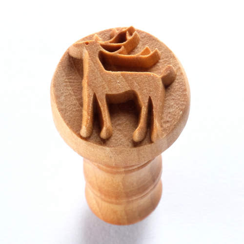 Wooden stamp featuring a detailed reindeer design, ideal for clay decorating and pottery embellishment.